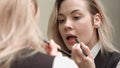 Young beautiful woman applying red lipstick on her lips Royalty Free Stock Photo