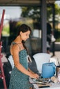 Young woman artist stands close table with a palette