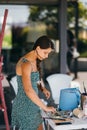 Young woman artist stands close table with a palette