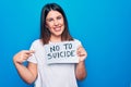 Young beautiful woman asking for psychical problem holding paper with not to suicide message smiling happy pointing with hand and