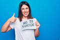 Young beautiful woman asking for psychical problem holding paper with not to suicide message smiling happy and positive, thumb up