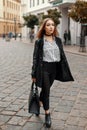 Young beautiful woman in autumn coat with stylish bag, shoes