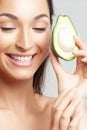 Young beautiful woman with avocado closeup