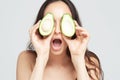 Young beautiful woman with avocado closeup