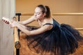 Young and beautiful woman in ballet dress and pointe dance. The ballerina warms up in the classroom. The ballerina`s Royalty Free Stock Photo