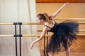 Young and beautiful woman in ballet dress and pointe dance. The ballerina warms up in the classroom. The ballerina`s Royalty Free Stock Photo