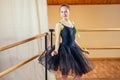 A young and beautiful woman in a ballet dress and pointes measures tape the measurement of waist measurement flight in Royalty Free Stock Photo