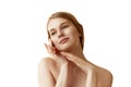 Young beautiful woman with bares shoulders, posing gently touching her face and framing it against white studio Royalty Free Stock Photo