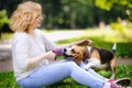 Young beautiful woman with Beagle dog in the summer park Royalty Free Stock Photo