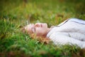 Young beautiful woman. Beauty girl lying on grass, closed eyes Royalty Free Stock Photo