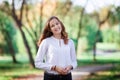 Young beautiful woman. Beauty smiling teenager girl in autumn park Royalty Free Stock Photo