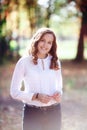 Young beautiful woman. Beauty smiling teenager girl in autumn park Royalty Free Stock Photo