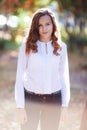 Young beautiful woman. Beauty smiling teenager girl in autumn park Royalty Free Stock Photo