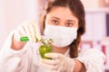 Young beautiful woman biologist experimenting with