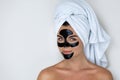 Young and beautiful woman with black peel-off mask on her face Royalty Free Stock Photo