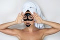 Young and beautiful woman with black peel-off mask on her face Royalty Free Stock Photo