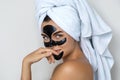 Young and beautiful woman with black peel-off mask on her face Royalty Free Stock Photo
