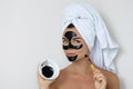 Young and beautiful woman with black peel-off mask on her face Royalty Free Stock Photo