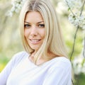 Young beautiful woman in blooming garden