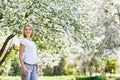 Young beautiful woman in blooming spring garden. Royalty Free Stock Photo