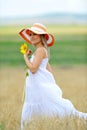 Young beautiful woman on blooming sunflower field Royalty Free Stock Photo