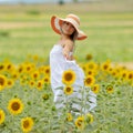 Young beautiful woman on blooming sunflower field Royalty Free Stock Photo