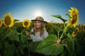 Young beautiful woman on blooming sunflower field Royalty Free Stock Photo