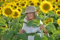 Young beautiful woman on blooming sunflower field Royalty Free Stock Photo