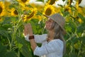 Young beautiful woman on blooming sunflower field Royalty Free Stock Photo