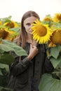 Young beautiful woman on blooming sunflower field in summer, health and lifestyle Royalty Free Stock Photo