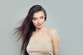 Young beautiful woman with blowing hair looking at background Royalty Free Stock Photo