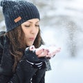 Young beautiful woman blowing snow in winter Royalty Free Stock Photo