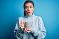 Young beautiful woman with blue eyes drinking mug of coffee over isolated background scared in shock with a surprise face, afraid Royalty Free Stock Photo