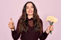 Young beautiful woman with blue eyes holding bouquet of yellow flowers over pink background happy with big smile doing ok sign, Royalty Free Stock Photo