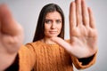 Young beautiful woman with blue eyes wearing casual sweater making selfie by camera with open hand doing stop sign with serious Royalty Free Stock Photo