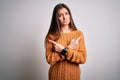 Young beautiful woman with blue eyes wearing casual sweater standing over white background Pointing to both sides with fingers, Royalty Free Stock Photo