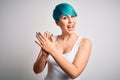 Young beautiful woman with blue fashion hair wearing casual t-shirt over white background clapping and applauding happy and Royalty Free Stock Photo