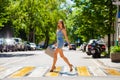 Young beautiful woman in a blue short dress walking on the road Royalty Free Stock Photo