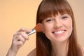 Young beautiful woman blushing with brush Royalty Free Stock Photo