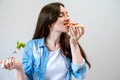 Young beautiful woman breaks the diet, but happy eats pizza instead of salad Royalty Free Stock Photo