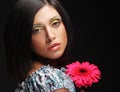 Beautiful woman with bright make up holding pink gerber flower Royalty Free Stock Photo