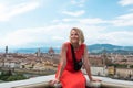 Woman stands against the backdrop of the panorama of Florence, Italy.