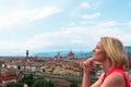 Woman stands against the backdrop of the panorama of Florence, Italy.