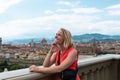 Woman stands against the backdrop of the panorama of Florence, Italy.