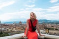 Woman stands against the backdrop of the panorama of Florence, Italy.