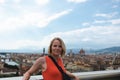 Woman stands against the backdrop of the panorama of Florence, Italy.