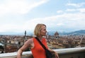 Woman stands against the backdrop of the panorama of Florence, Italy.