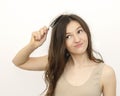 A young woman brunette brushes her hair Royalty Free Stock Photo