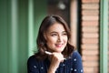 Young beautiful woman in the cafe near the window, thinking and writing something. Royalty Free Stock Photo