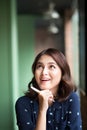 Young beautiful woman in the cafe near the window, thinking and writing something Royalty Free Stock Photo